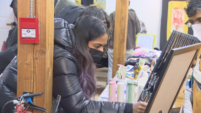 A shopper stops to look at earrings. 