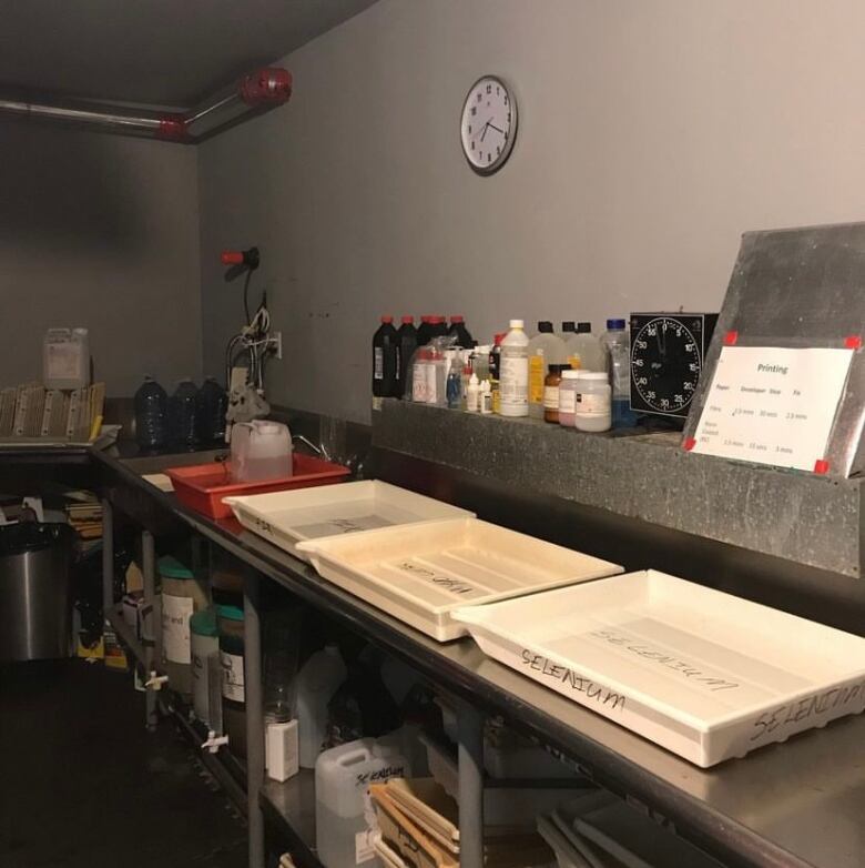 A room with trays and bottles of liquid in the background. 