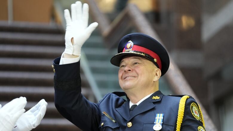 Incoming Toronto Police Chief Myron Demkiw waves after taking the oath of office during a police change of command ceremony in Toronto, Monday, Dec.19, 2022.