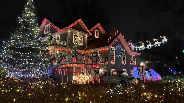 A home is covered with Christmas lights in various colours.