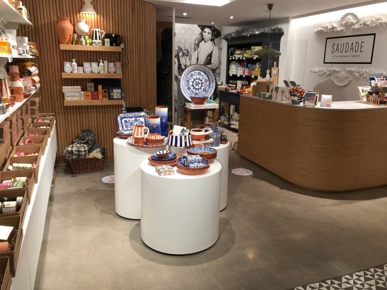 Ceramic dishes and other products are displayed in a small shop.