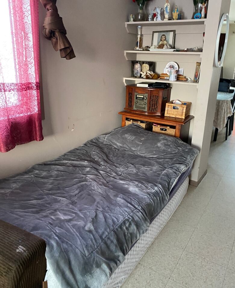 A single mattress is shown in the living room. 