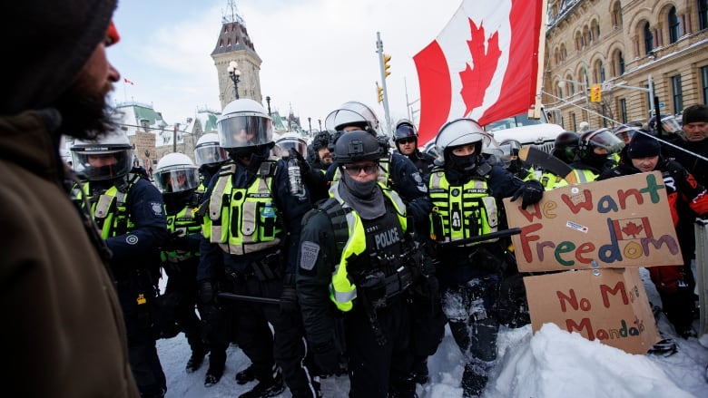 Police clear an area of protesters near Parliament Hill.