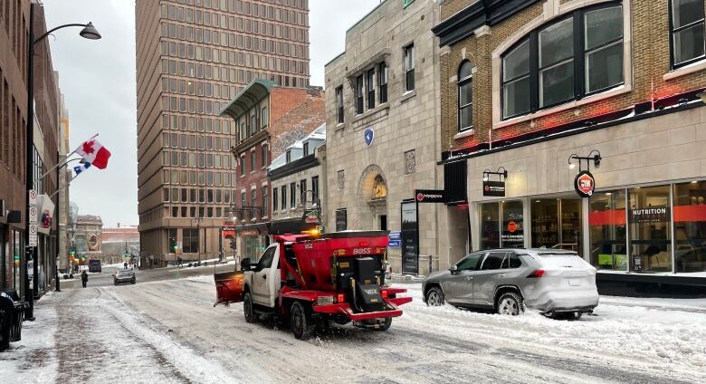 a snow plow clears the streets in Quebec City