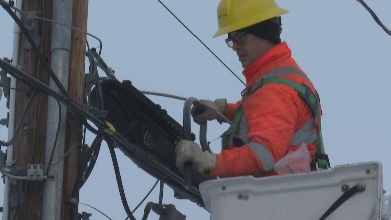 A Bell-Aliant worker repairs fibre-op lines that were cut by thieves on Fredericton's north side earlier this week.