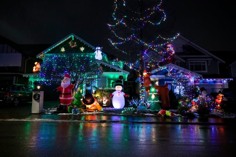 A photo of Christmas decorations outside a house at Santa Claus Lane (84th Avenue and 209A Street) decked in twinkly lights and holiday trimmings in Langley, B.C.