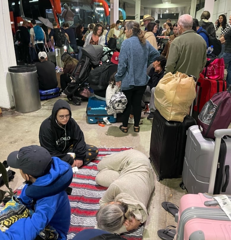 Passengers are seen as they await transport at the airport in Cancun, Mexico on Christmas Day. 