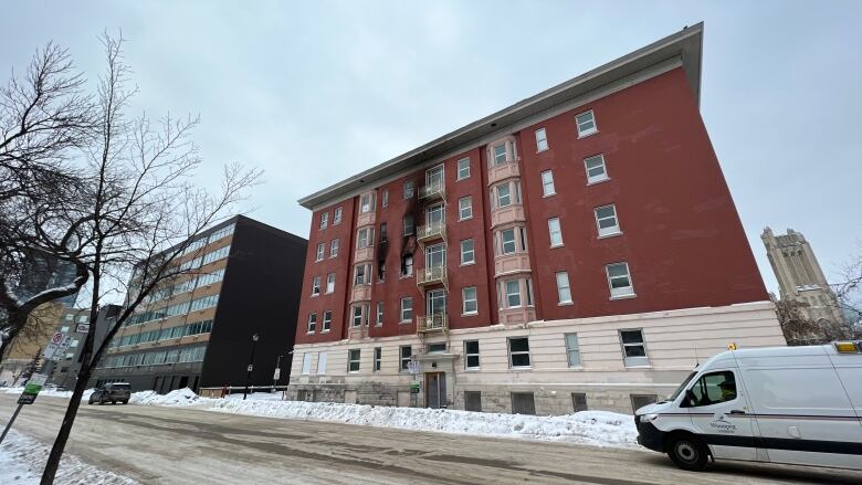 An apartment with fire damage on the the building's exterior.