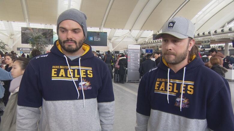 Two men stand side by side wearing Burlington Eagles-branded sports attire.