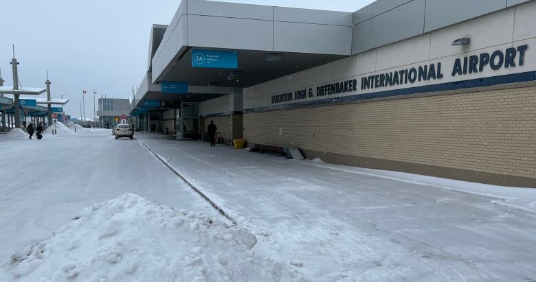 The Saskatoon airport with the snowy roadway in front of it