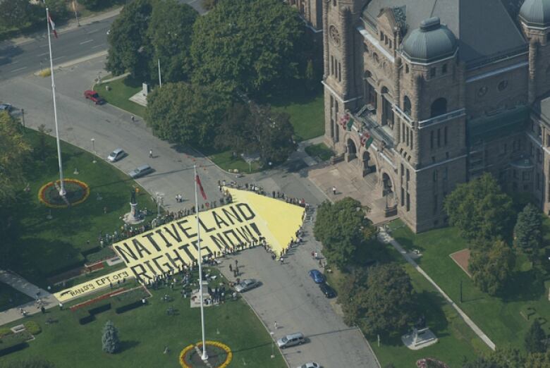 An aerial photo shows a yellow arrow with the words 