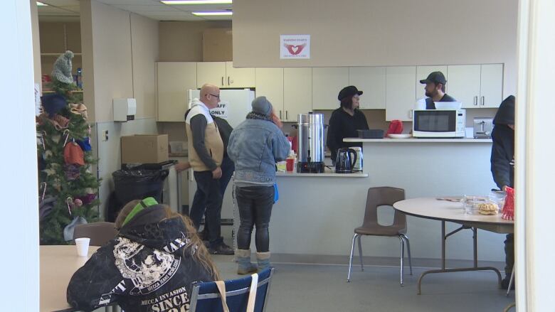 Volunteer and clients interact in the main dinning area of the Warming Centre in Drayton Valley.