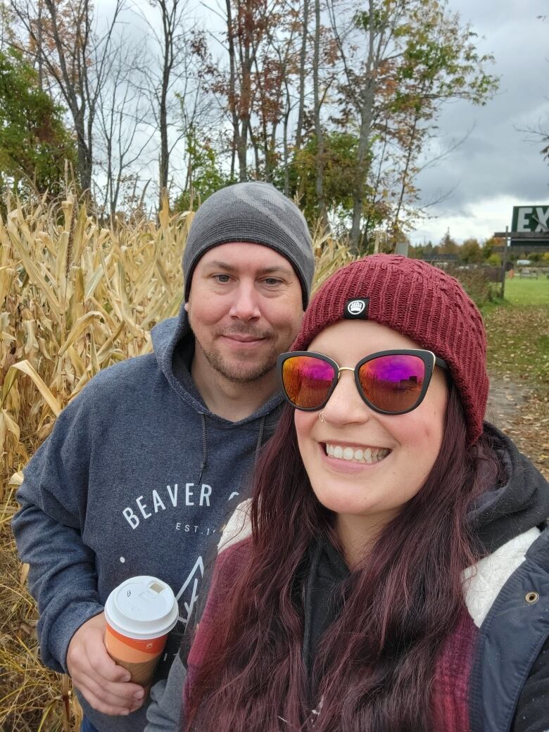 A woman and a man look into the camera.