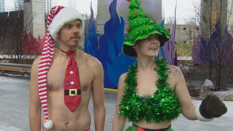 Christopher Kotsopoulos and Nicci Sharpe are dressed in holiday costumes while skating during the Polar Bear Skate at The Bentway skating rink.