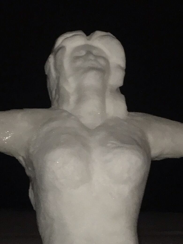 A close up of the the head of a snow sculpture of a woman.