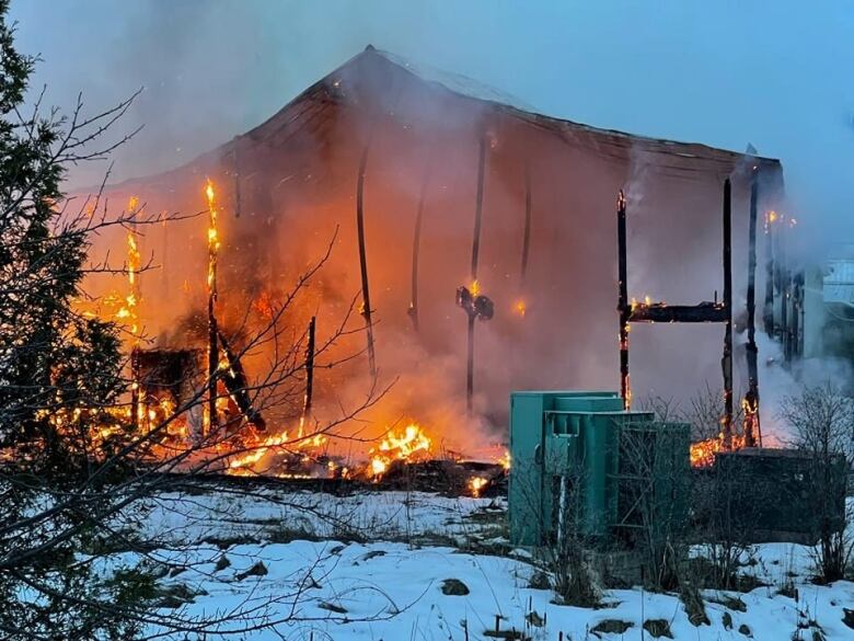 Fire consumes the sides of a building.