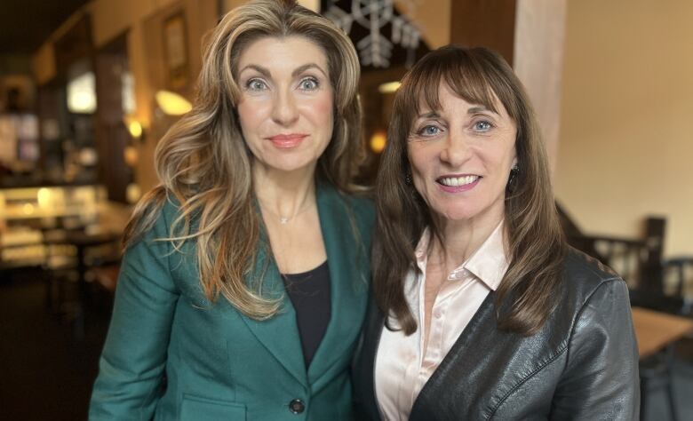 Two women with long hair.