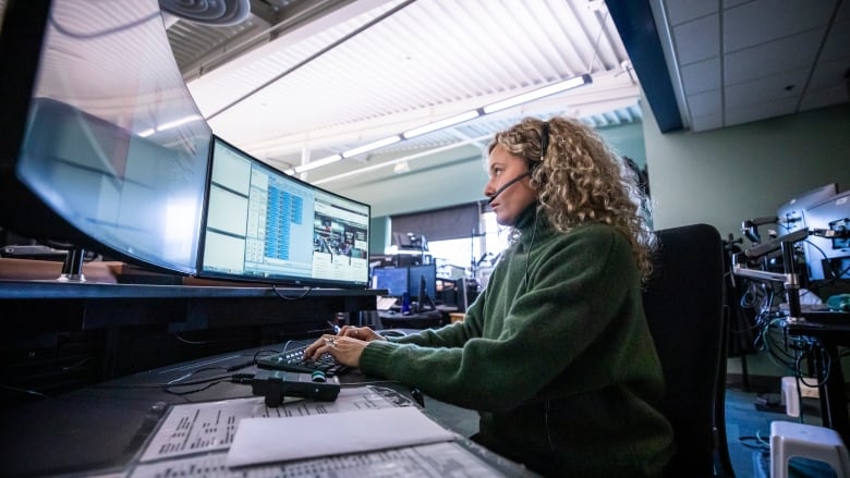 9-1-1 call taker Madison Sheane takes emergency calls at Vancouvers E-Comm centre in Vancouver, British Columbia on Monday, December 9, 2019. 