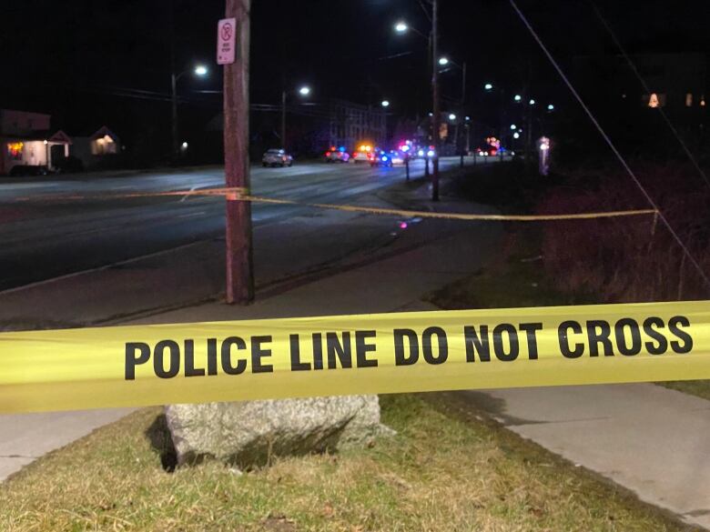 police tape across a street at night