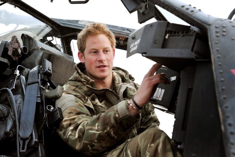 A person is seen inside a helicopter cockpit.