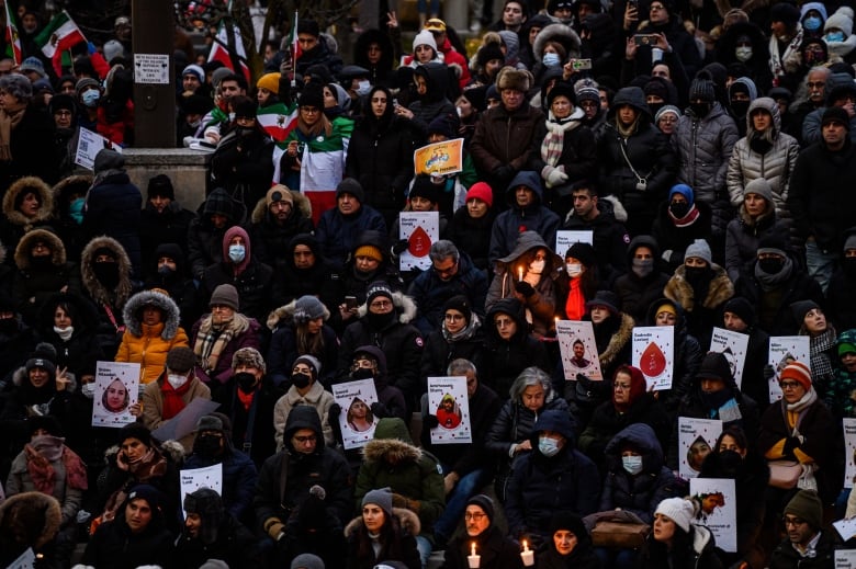 People attend a vigil marking the three year anniversary of the downing of flight PS752, in Toronto on Sunday, Jan. 8, 2023.