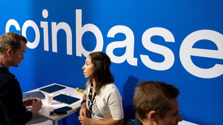 Coinbase booth at Paris blockchain show is shown.