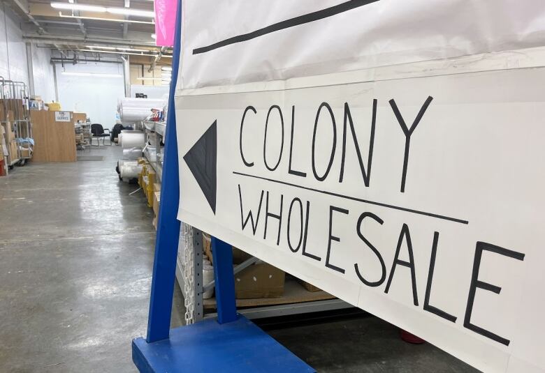 A sign that says Colony Wholesale