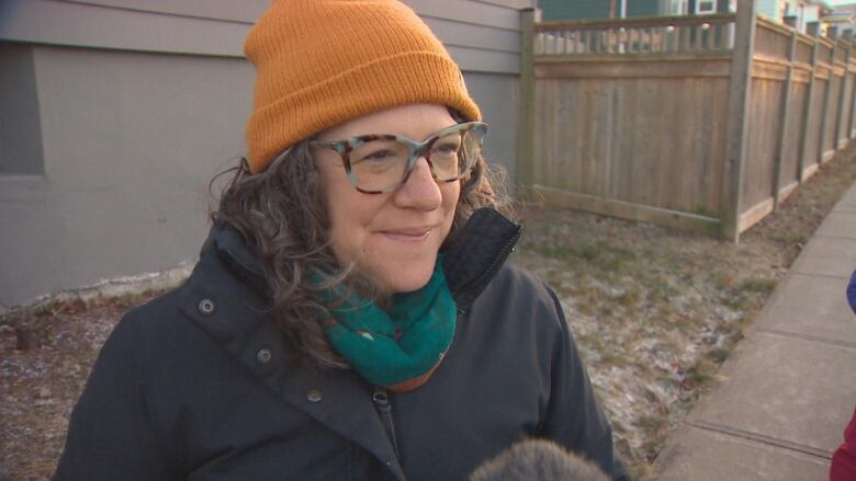 A woman with an orange beanie