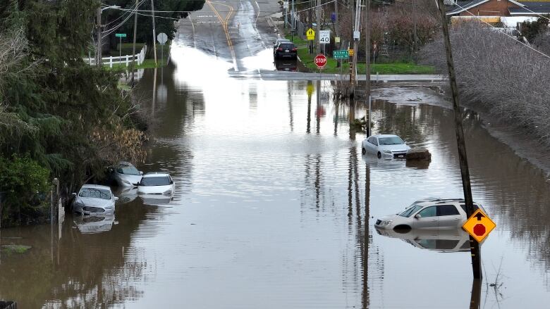 An aerial view of cars sitting in floodwaters in Planada, Calif.