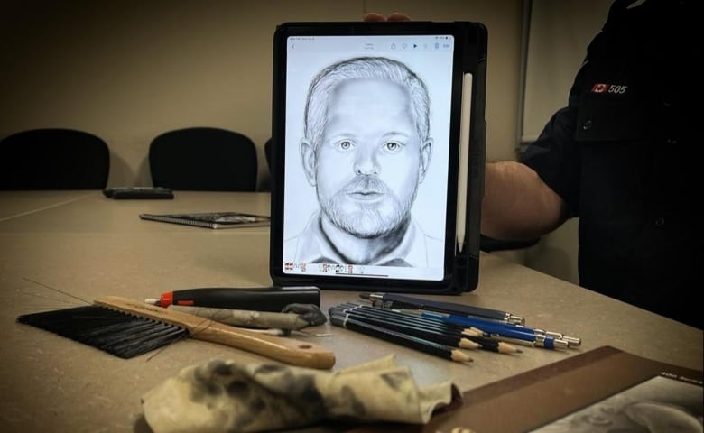 An iPad with a composite sketch on it and pencils and brush in front of it. 