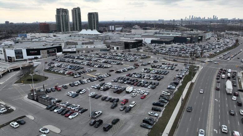 Aerial (drone) images of last-minute shoppers at Sherway Gardens and surrounding shopping areas. Shots of Best Buy, Winners, Walmart and Home Depot parking lots. 