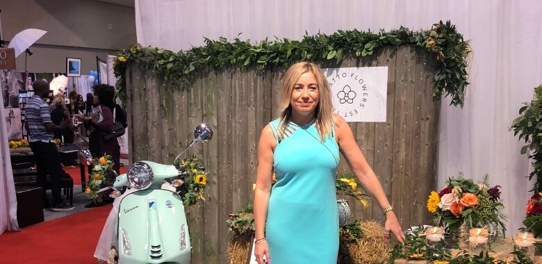 Teale Malek, Canada's Bridal Show manager, stands in front of a booth at the Toronto Metro Convention Centre on Friday.