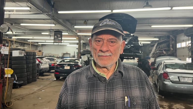 Man standing in mechanic's garage