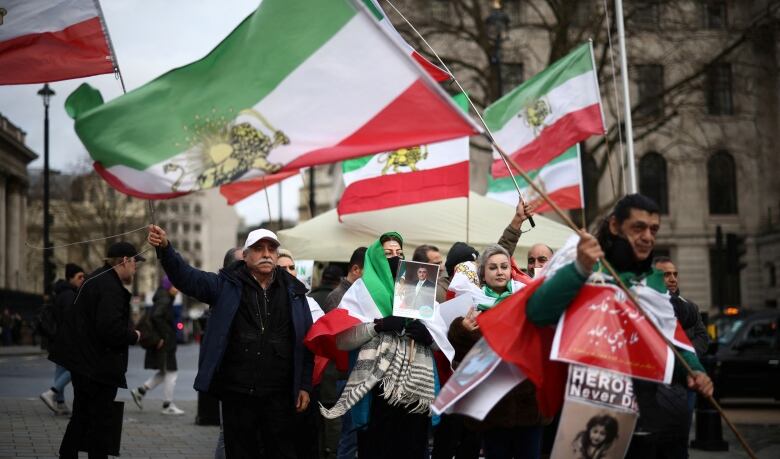 Protesters in London carry flags.