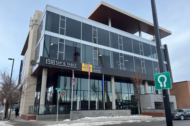 A building is shown with a yellow sign that reads for lease