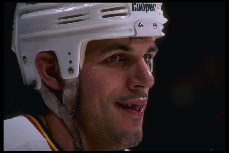 A hockey player looks on during a game.