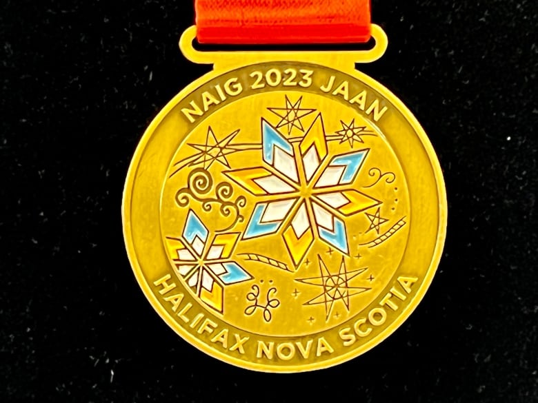 A gold medal with blue and white stars.