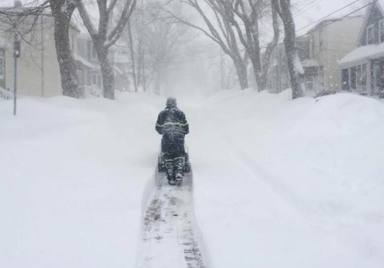 A man clears a path on his street in Halifax on March 18th 2015. 