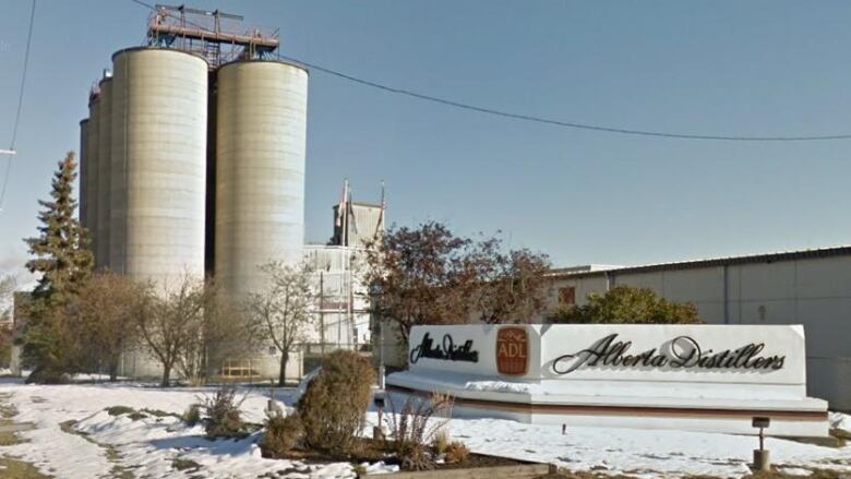 A distillery building with several silos is seen in an industrial area of Calgary.