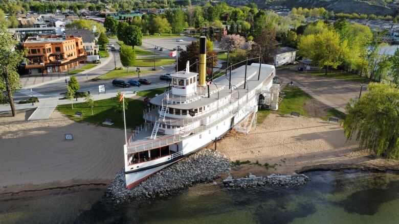 Aerial view of a big white steam ship displayed near a beach.