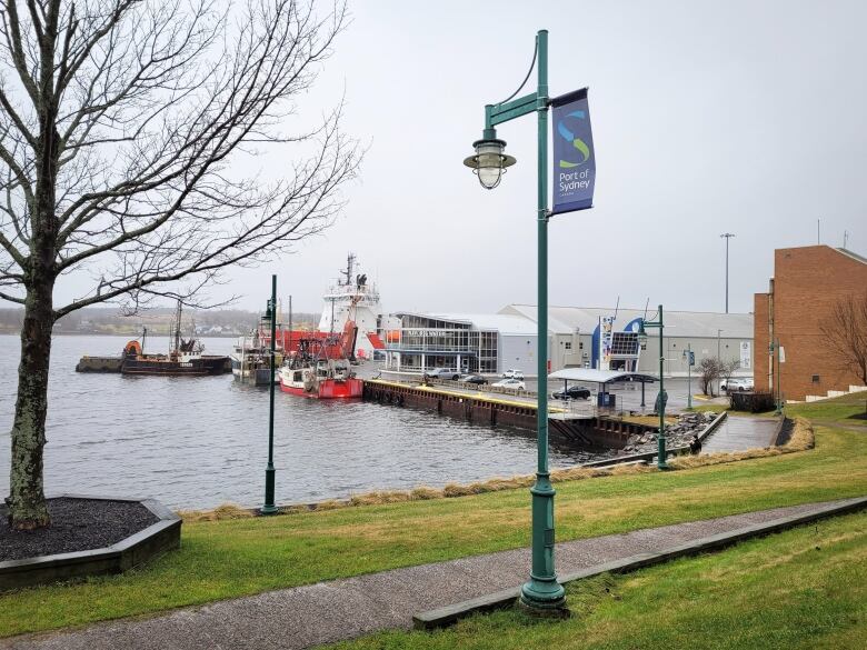 A marine terminal building and waterfront docks with ships tied up is shown.