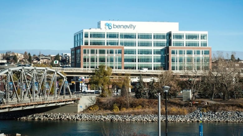 An office is pictured next to a bridge and a lake.