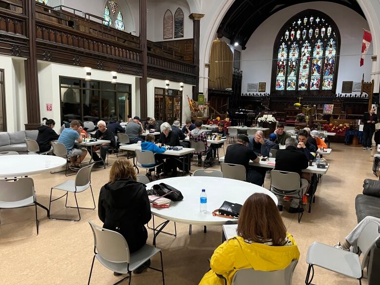 Community members sit in Stone Church. 