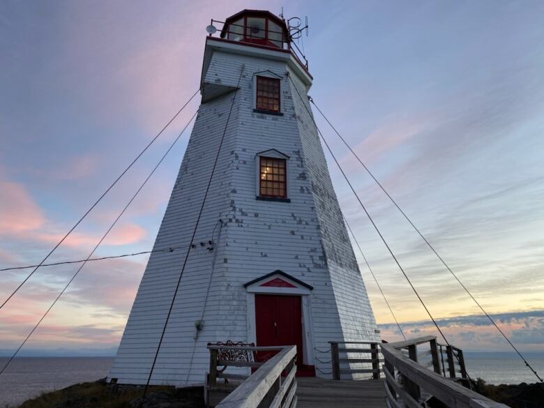 Swallowtail lighthouse with weathered shingles. 