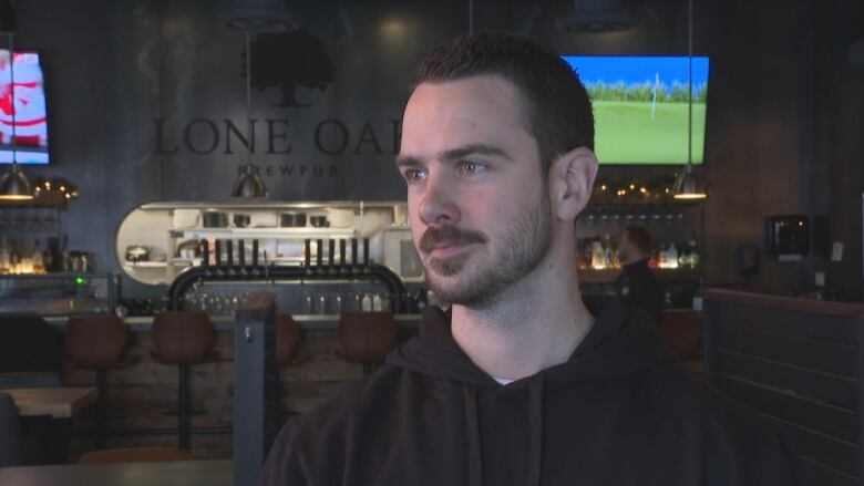 Jared Murphy stands in front of his brewing company. 