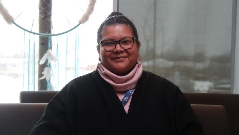 A woman sits in the college campus located in Thompson, Manitoba