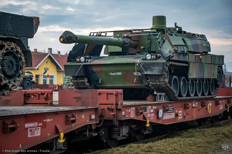 A tank is transported by train.