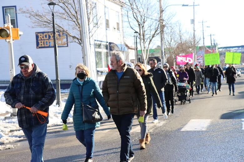 A group of people marches through downtown Sydney on Sunday, Jan. 22nd to demand better health-care services. 