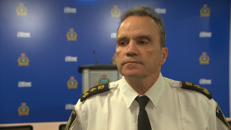 Winnipeg's police chief standing in a police-headquarters meeting room.