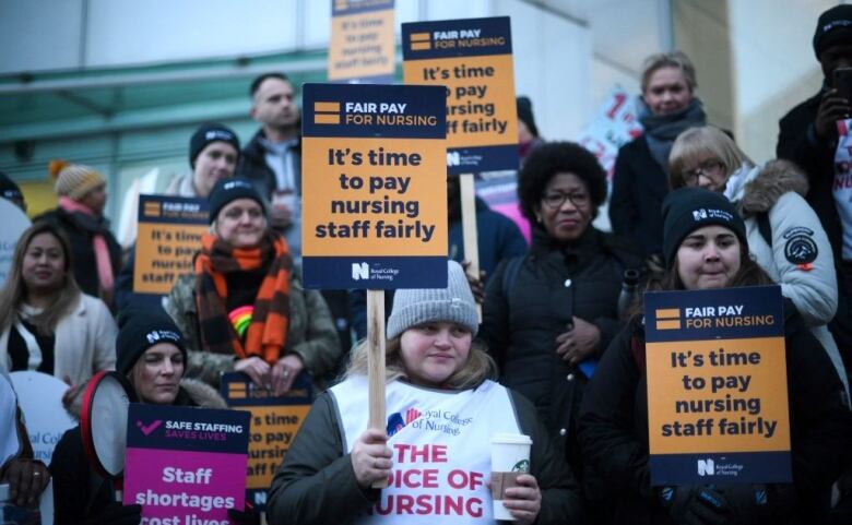 Nurses strike holding placards that read: It's time to pay nursing staff fairly